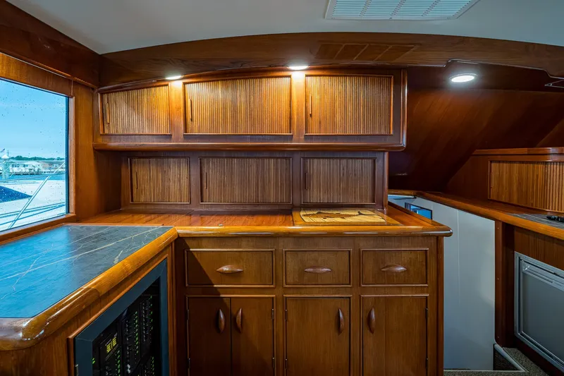 Slide: The Image of Interior of 1986 Buddy Davis 47 Convertible yacht with wooden cabinetry and countertop. - 72