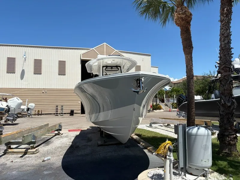 Slide: The Image of A 2022 Regulator 31 boat is on a dry dock in front of a building with palm trees. - 4