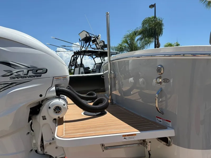 Slide: The Image of 2022 Regulator 31 with XTO Offshore engine, teak flooring, and fishing rod holders. - 2