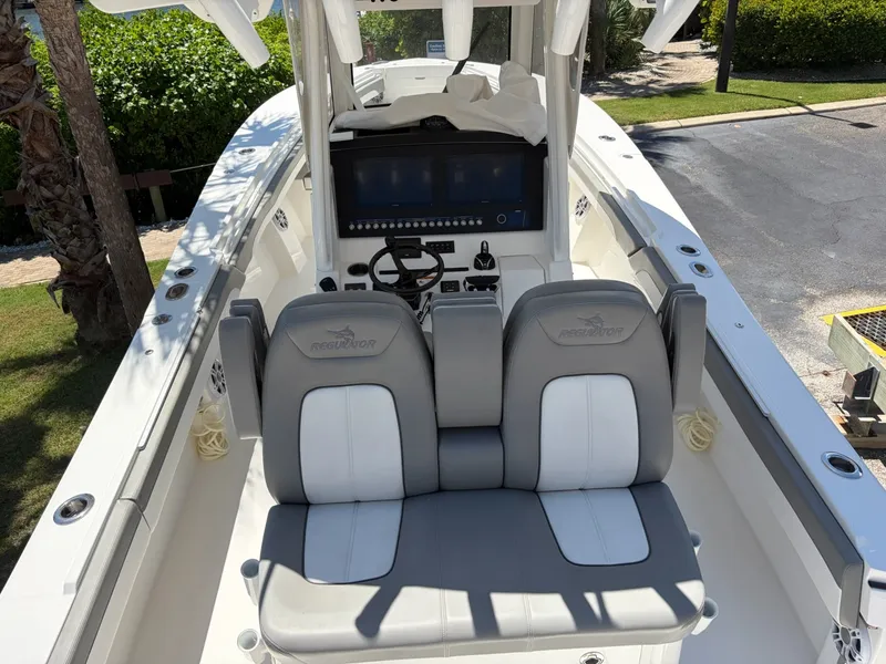 Slide: The Image of The image shows the cockpit of a 2022 Regulator 31 boat with gray and white seating. - 22