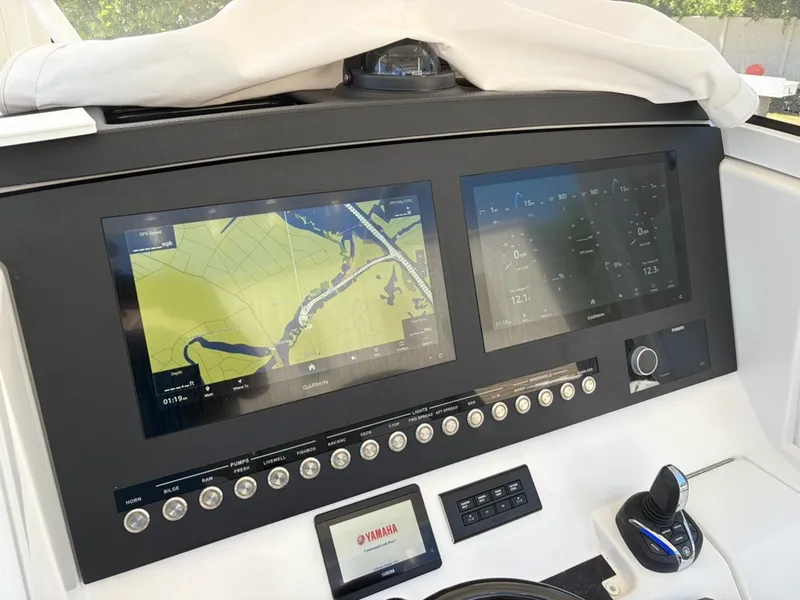 Slide: The Image of The image shows the dashboard of a Regulator 31 boat with two large navigation screens. - 21