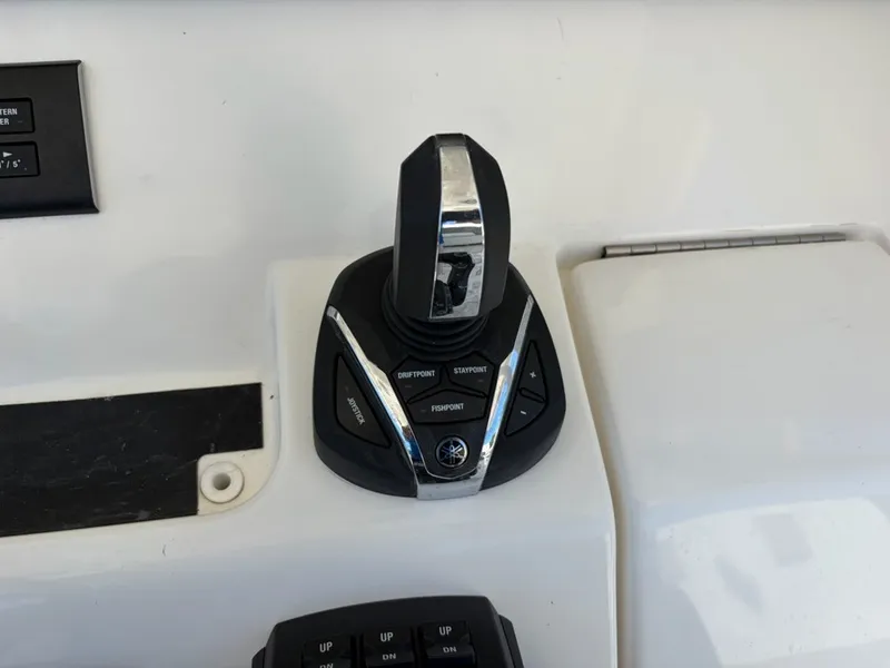 Slide: The Image of Close-up of a modern boat throttle control on a 2022 Regulator 31. - 11
