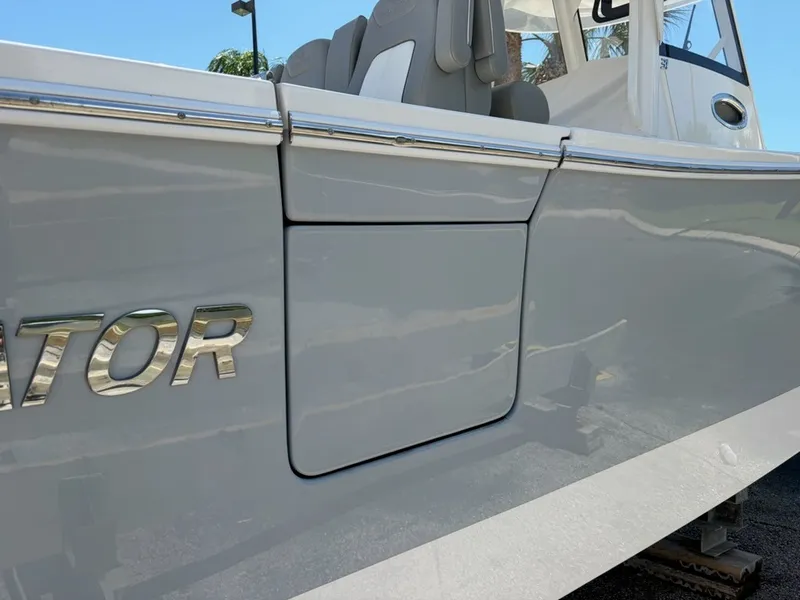 Slide: The Image of Close-up of a gray boat hull with "Regulator" lettering and a hatch. - 3