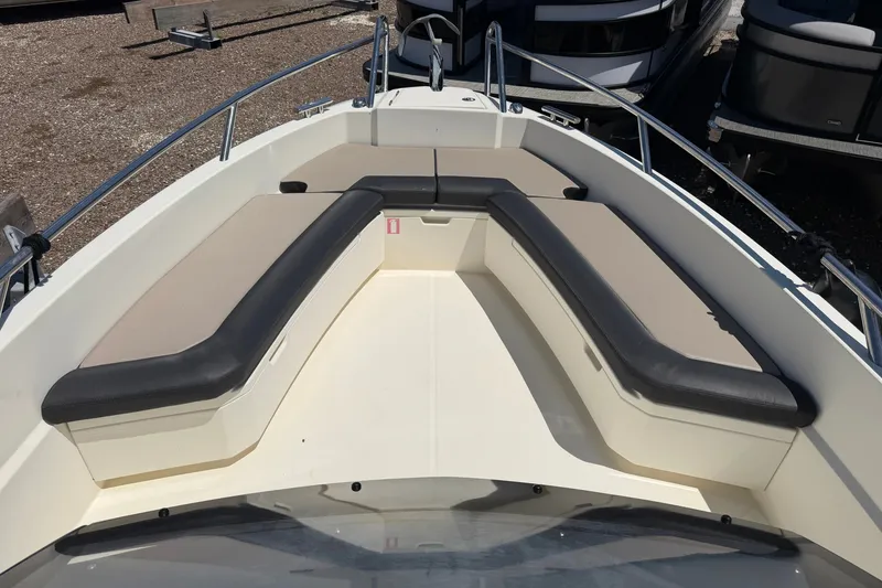 Slide: The Image of 2021 Parker Poland 690 Sport boat interior with cushioned seating and metal railings. - 17