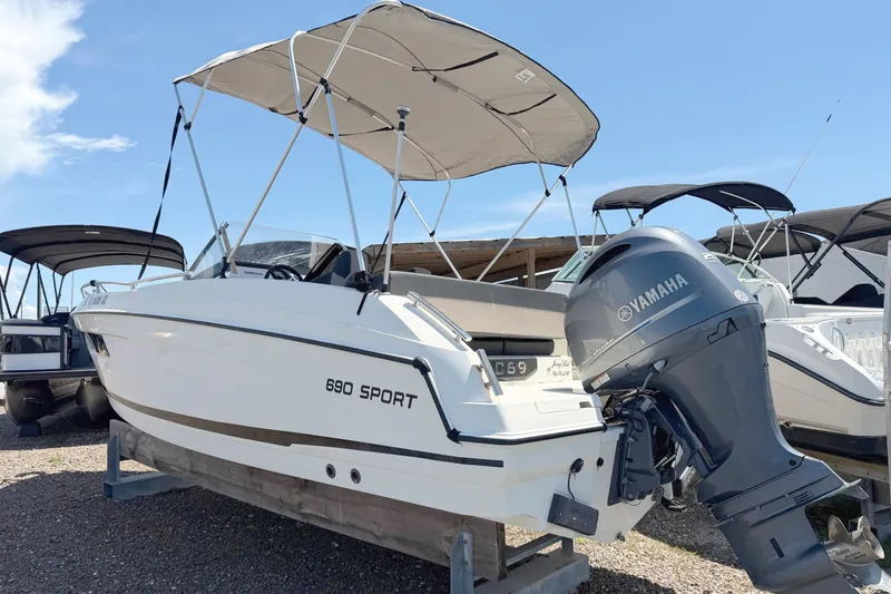 Slide: The Image of 2021 Parker Poland 690 Sport boat with Yamaha engine, displayed outdoors under a clear sky. - 2