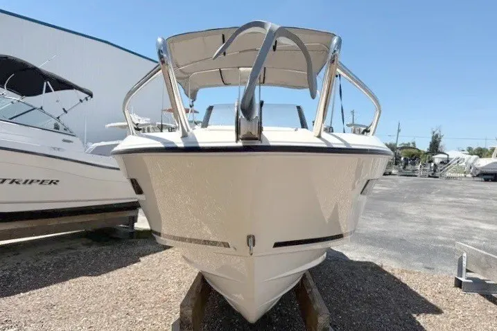 Slide: The Image of 2021 Parker Poland 690 Sport boat, front view, parked outdoors under clear blue sky. - 6