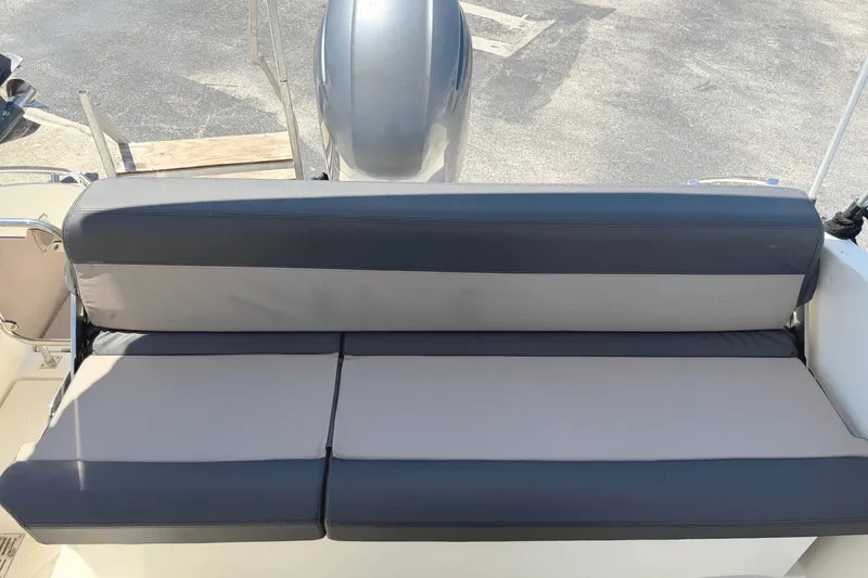 Slide: The Image of 2021 Parker Poland 690 Sport boat with cushioned seating and outboard motor. - 7