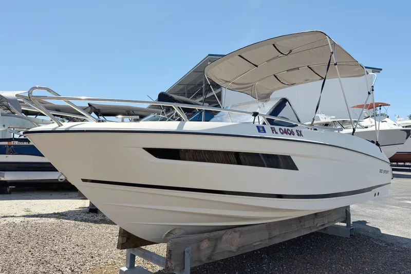 Slide: The Image of A 2021 Parker Poland 690 Sport boat with a sunshade, on a dry dock. - 1