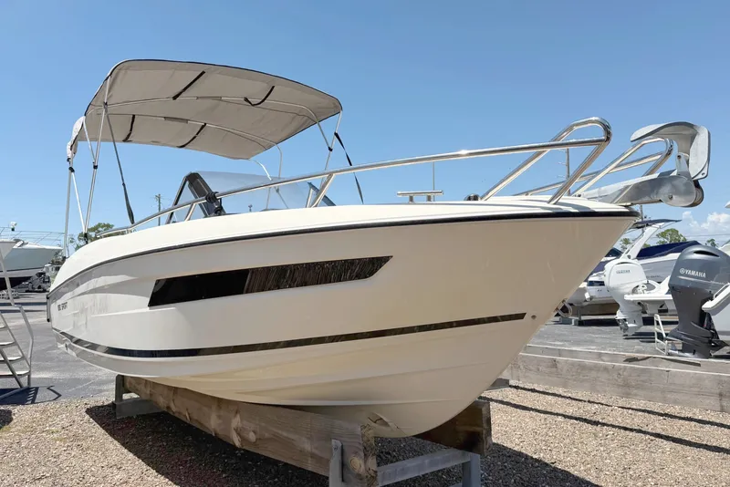 Slide: The Image of 2021 Parker Poland 690 Sport boat with canopy, displayed outdoors on a sunny day. - 5
