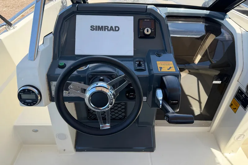 Slide: The Image of Dashboard of 2021 Parker Poland 690 Sport boat with steering wheel and controls. - 12