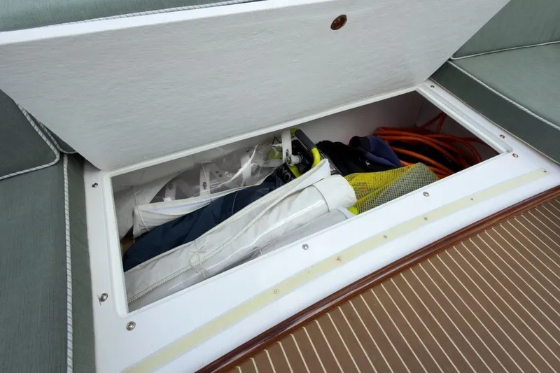 Slide: The Image of Storage compartment on 2023 Fortier 33 boat, containing various boating equipment. - 15