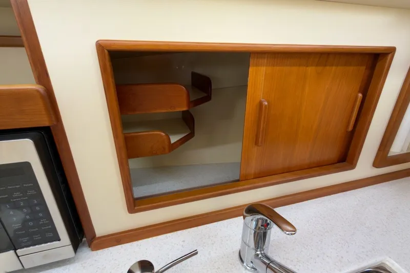 Slide: The Image of Wooden cabinet with sliding doors in 2023 Fortier 33 boat kitchen. - 58