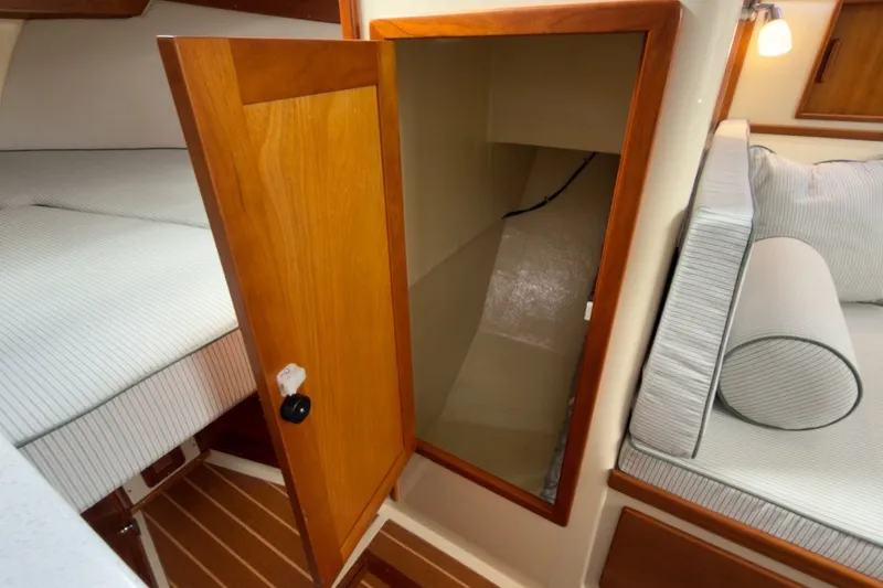Slide: The Image of Interior of 2023 Fortier 33 boat with open wooden storage compartment. - 51
