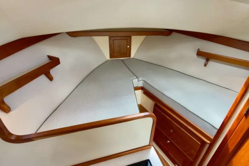 Slide: The Image of 2023 Fortier 33 boat interior with cozy V-berth and wooden accents. - 43