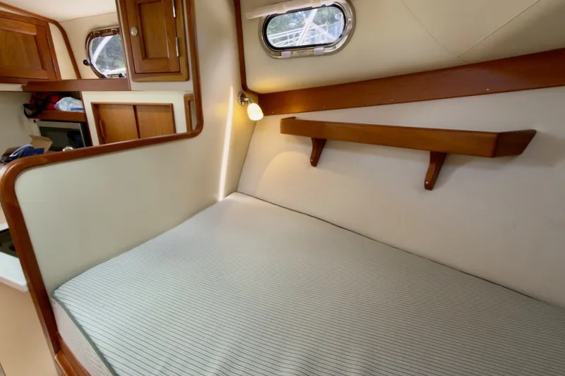 Slide: The Image of Cozy cabin interior of 2023 Fortier 33 boat with wooden accents and comfortable bedding. - 48
