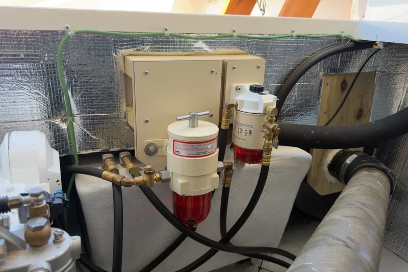 Slide: The Image of Engine compartment of 2023 Fortier 33 boat with fuel filters and hoses. - 71