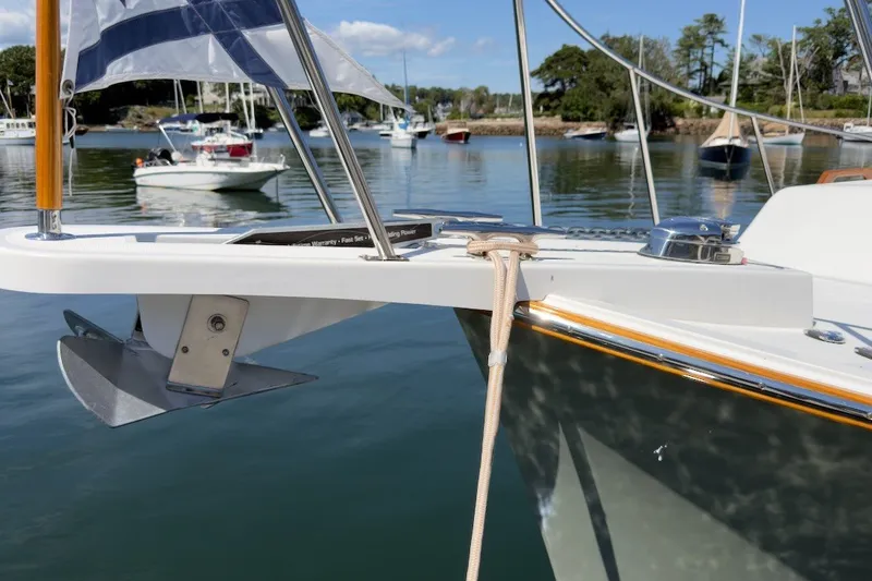 Slide: The Image of 2023 Fortier 33 boat anchored in a serene marina with clear skies. - 74