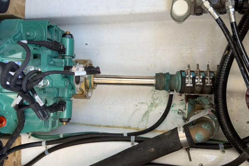 Slide: The Image of Engine compartment of a 2023 Fortier 33 boat, showcasing mechanical components and wiring. - 68