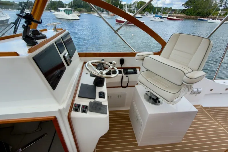 Slide: The Image of Helm of 2023 Fortier 33 boat with modern controls and comfortable seating. - 28