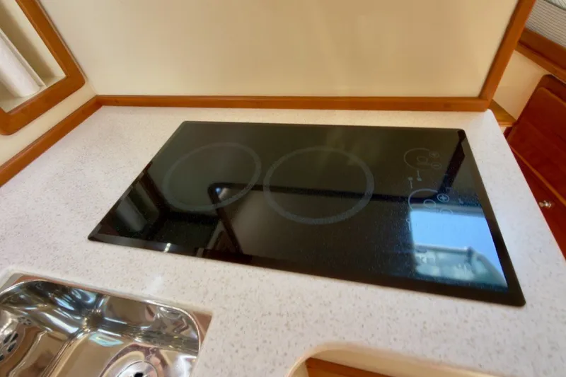 Slide: The Image of Modern kitchen cooktop on 2023 Fortier 33 boat, featuring sleek design and functionality. - 57