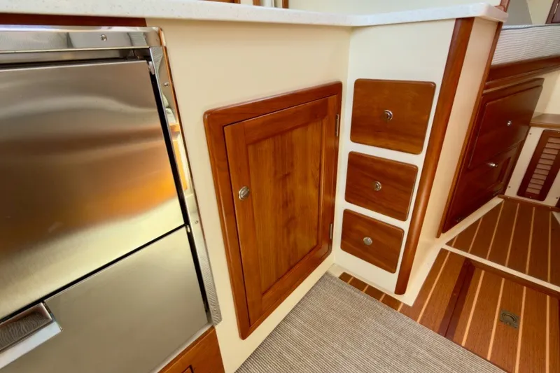 Slide: The Image of Interior of 2023 Fortier 33 boat with wooden cabinetry and stainless steel appliance. - 59