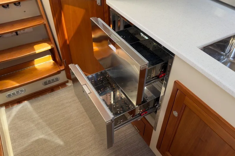Slide: The Image of Modern kitchen drawers in a 2023 Fortier 33 boat interior. - 55