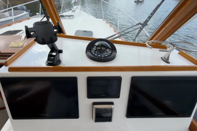 Slide: The Image of Helm of 2023 Fortier 33 boat with navigation instruments and compass. - 31