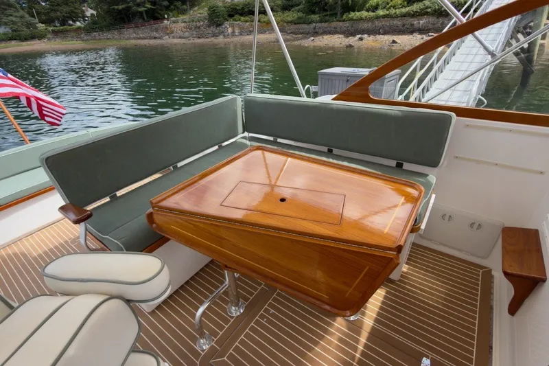 Slide: The Image of Elegant 2023 Fortier 33 boat interior with wooden table and cushioned seating. - 23