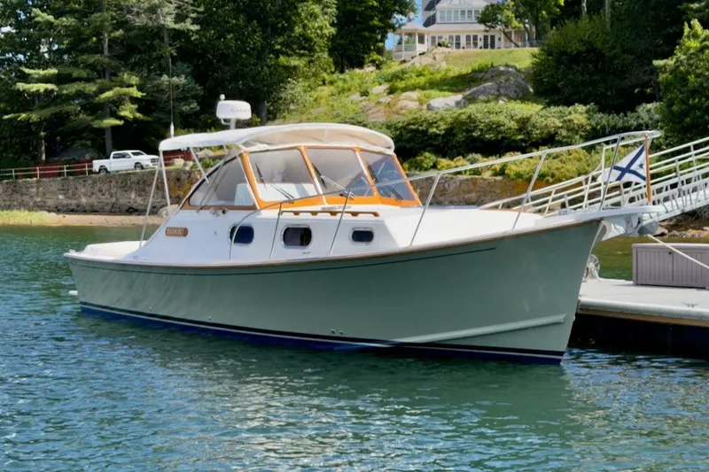 The Image of 2023 Fortier 33 at a calm dock with green landscape in the background. - 0