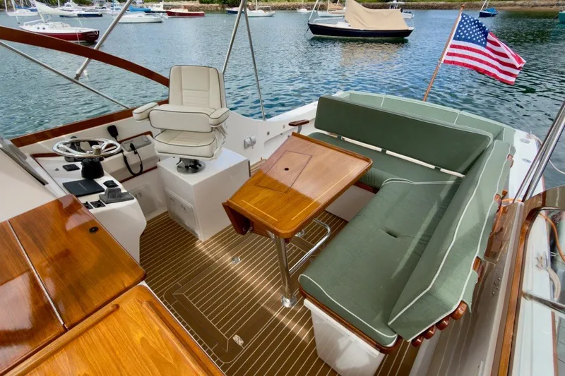 Slide: The Image of 2023 Fortier 33 boat interior with wooden accents and American flag. - 20