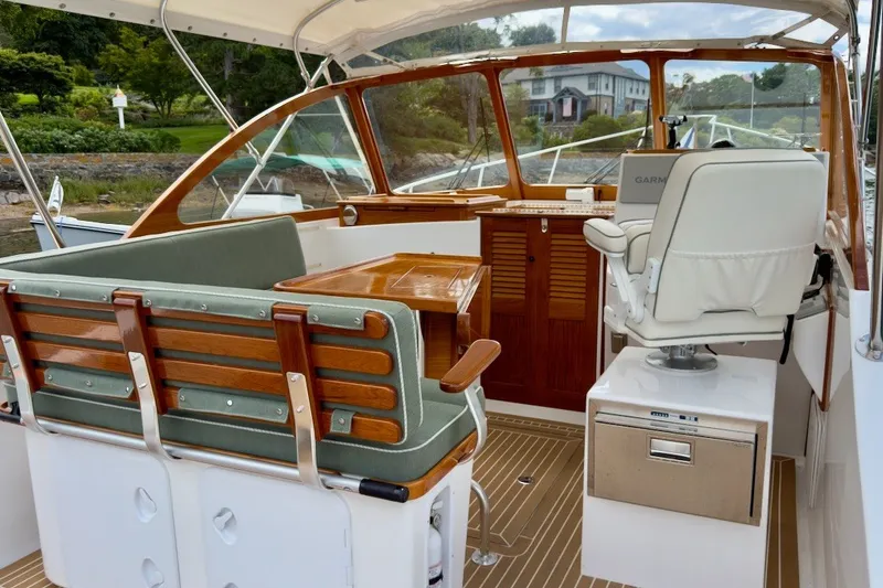 Slide: The Image of Interior of a 2023 Fortier 33 boat with elegant seating and wooden accents. - 18