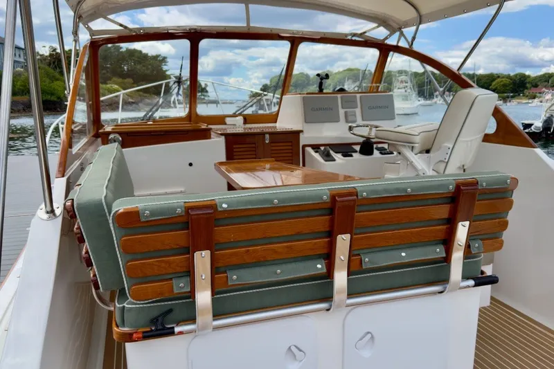Slide: The Image of 2023 Fortier 33 boat interior with wooden seating and Garmin navigation system. - 19