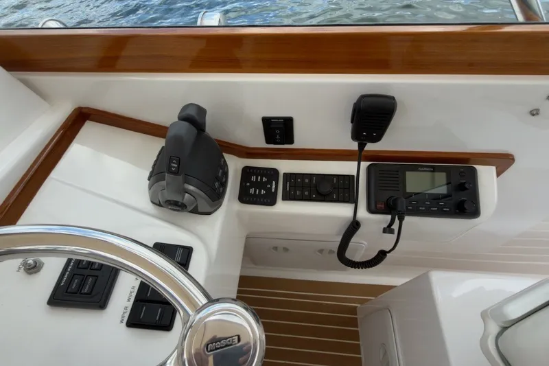 Slide: The Image of Control panel of 2023 Fortier 33 boat with steering wheel and navigation equipment. - 32