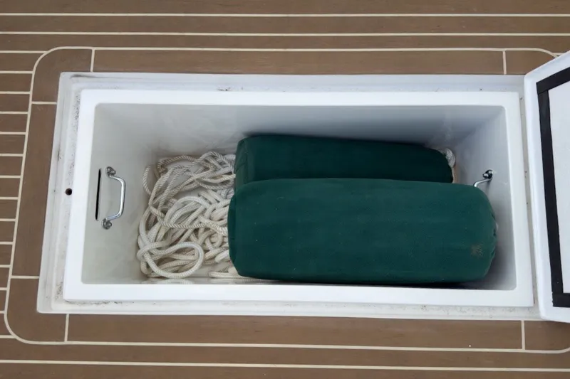 Slide: The Image of Storage compartment on 2023 Fortier 33 boat with ropes and green fenders. - 16