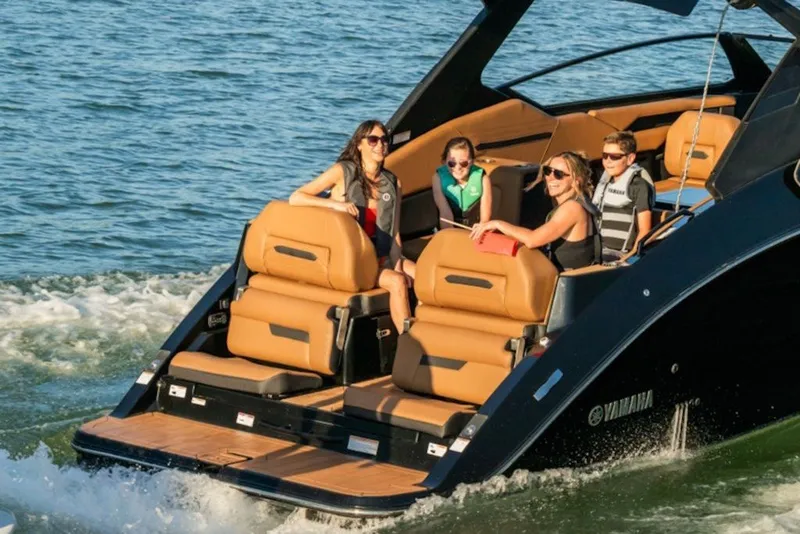 Slide: The Image of 2027 Yamaha Boats 295XD cruising with passengers on a sunny day. - 6
