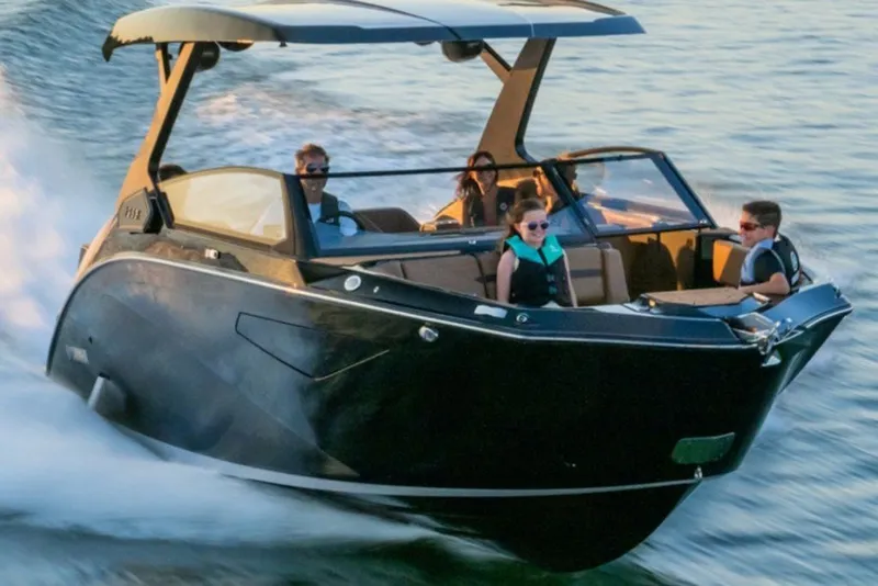 Slide: The Image of 2027 Yamaha Boats 295XD cruising on water with passengers enjoying the ride. - 4