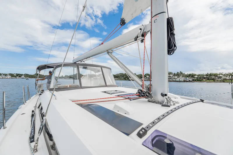 Slide: The Image of 2020 Beneteau Oceanis 46.1 sailboat on calm waters under a partly cloudy sky. - 14