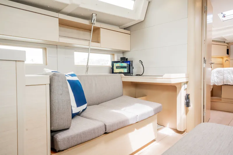 Slide: The Image of Interior of 2020 Beneteau Oceanis 46.1 yacht with modern seating and navigation station. - 21