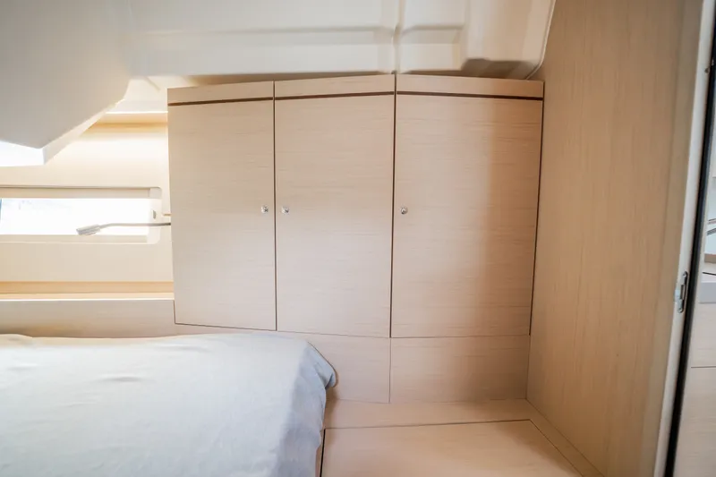 Slide: The Image of Interior cabin of 2020 Beneteau Oceanis 46.1 yacht, featuring sleek wooden cabinetry. - 32