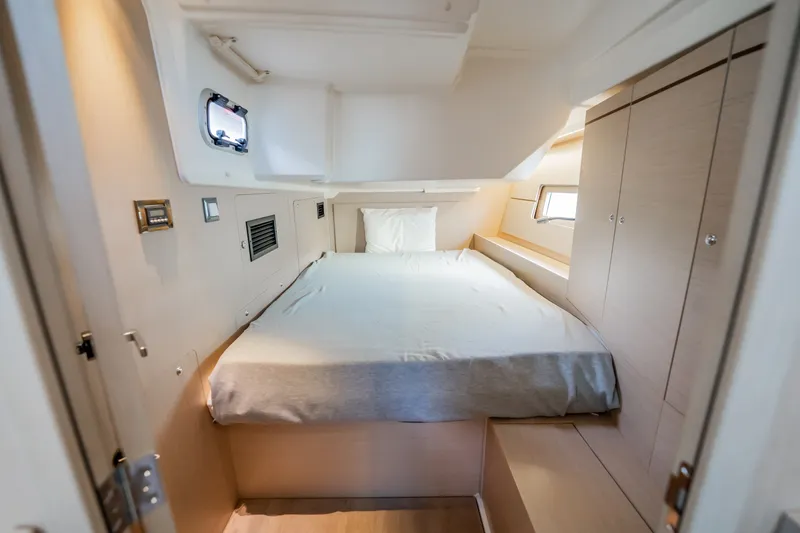 Slide: The Image of Interior cabin of 2020 Beneteau Oceanis 46.1 yacht, featuring a cozy bed and modern design. - 30