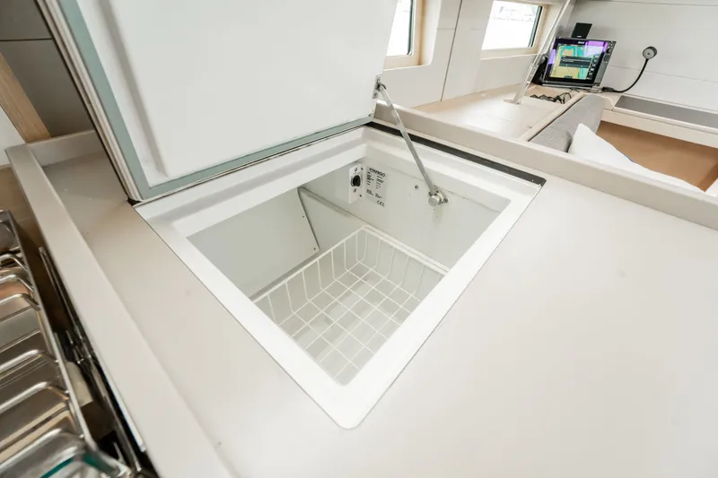 Slide: The Image of Interior view of 2020 Beneteau Oceanis 46.1 yacht kitchen with open freezer. - 25