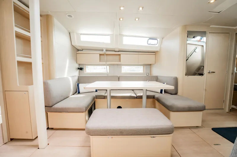 Slide: The Image of Interior of 2020 Beneteau Oceanis 46.1 yacht with modern seating and dining area. - 20