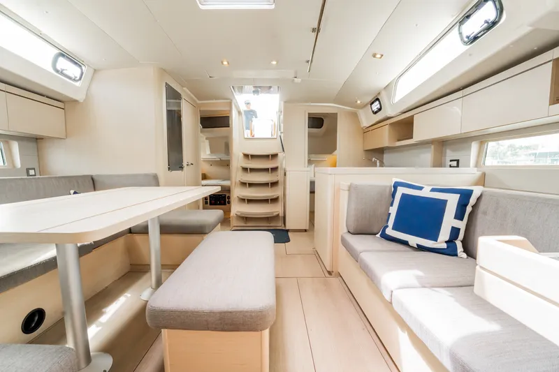 Slide: The Image of Interior of 2020 Beneteau Oceanis 46.1 yacht, featuring modern seating and dining area. - 17