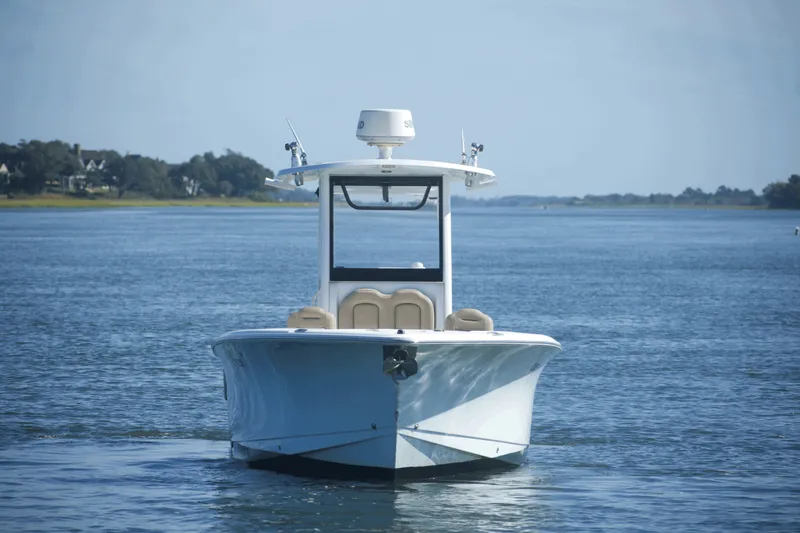 Slide: The Image of 2017 Sea Hunt Gamefish 27FS boat on calm water, front view. - 3