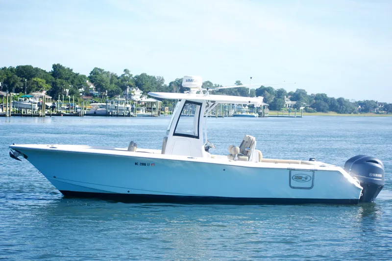 Slide: The Image of 2017 Sea Hunt Gamefish 27FS boat on calm water, scenic background. - 7