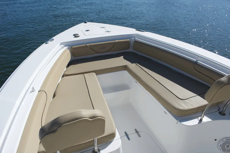 Slide: The Image of 2017 Sea Hunt Gamefish 27FS boat with tan seating, on calm water. - 9