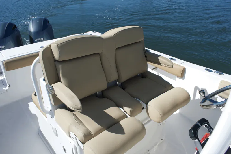Slide: The Image of 2017 Sea Hunt Gamefish 27FS boat interior with dual beige seats and twin engines. - 16