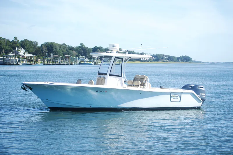 Slide: The Image of 2017 Sea Hunt Gamefish 27FS boat on calm water, side view. - 5