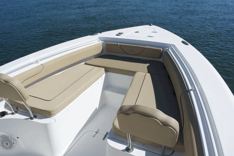 Slide: The Image of 2017 Sea Hunt Gamefish 27FS boat with beige seating on calm water. - 8