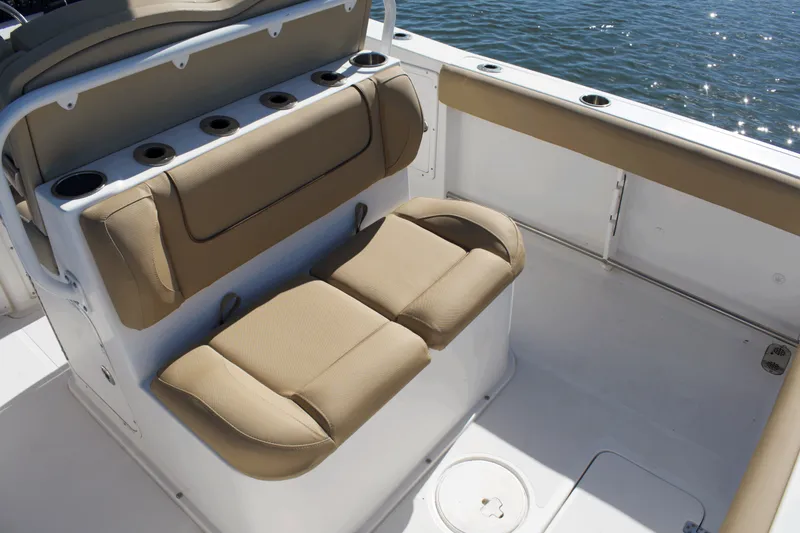 Slide: The Image of 2017 Sea Hunt Gamefish 27FS boat interior with tan seating and rod holders. - 19